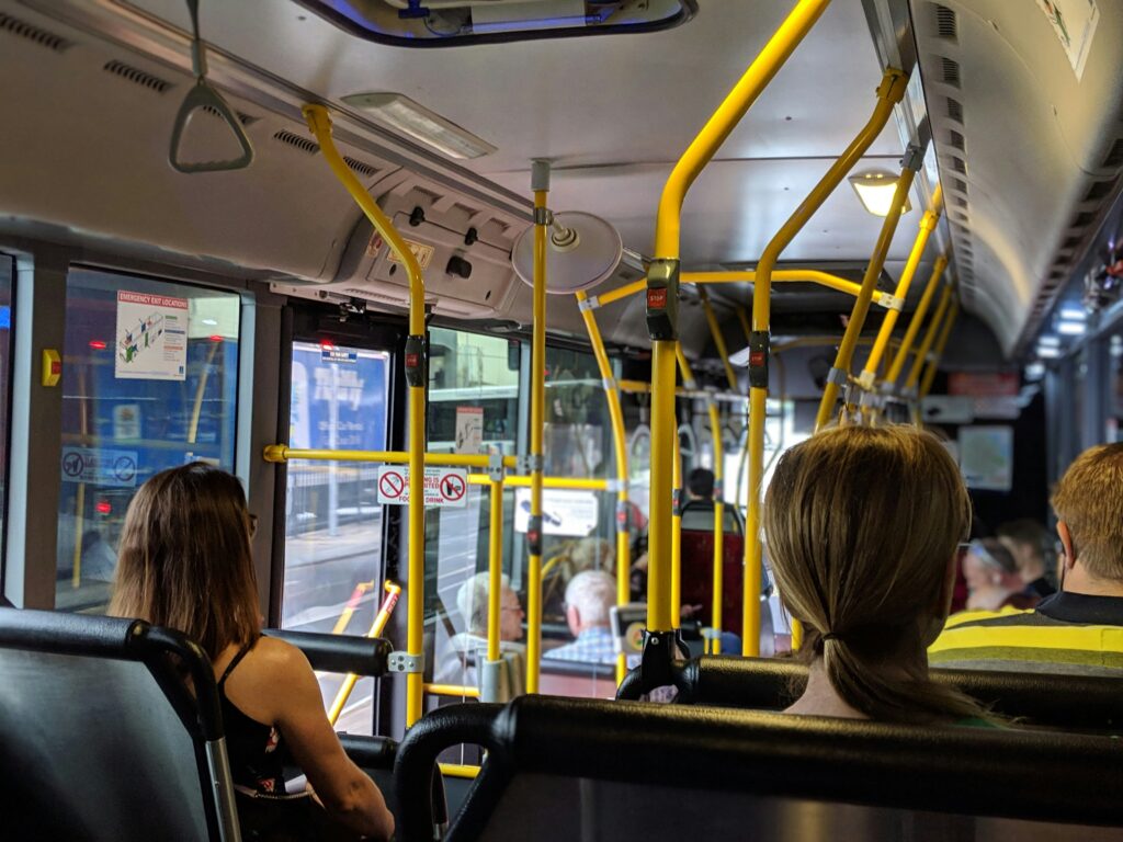public transit bus with people sitting in seats